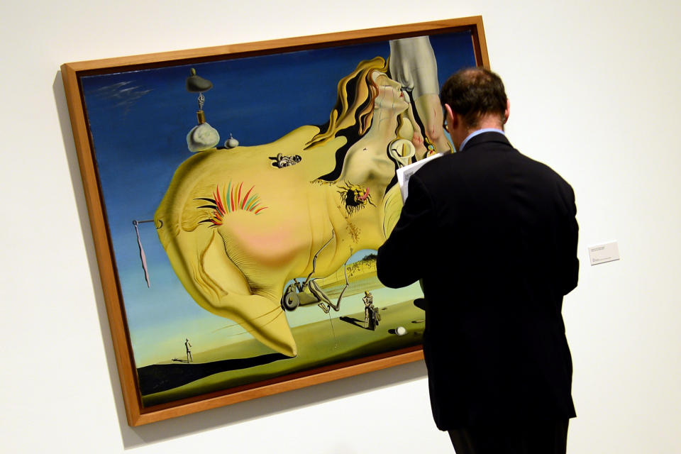 A man looks at a painting entitled 'The Great Masturbator' (1929) by Spanish surrealist artist Salvador Dali during the exhibition 'Dali. All of the poetic suggestions and all of the plastic possibilities' at the Reina Sofia museum in Madrid on April 25, 2013. (JAVIER SORIANO/AFP/Getty Images)