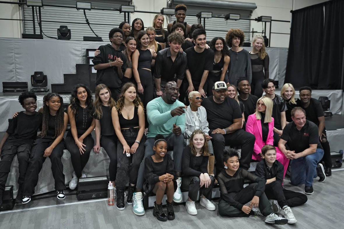 Cast and crew members pose for a photo for the touring show, “Hits! The Musical,” on Feb. 8, 2023 during a rehearsal in Clearwater, Florida. (AP Photo/Chris O’Meara)
