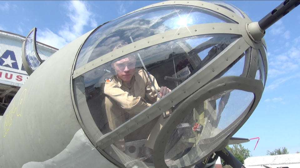 Chris Billings, the host for the upcoming documentary "Marauder Men: In Their Own Words," looks out from the bombardier's position of a B-26 Marauder at the MAPS Air Museum in Green.