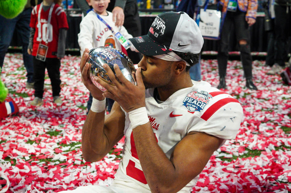 Dec. 30, 2023; Atlanta, Georgia; Mississippi Rebels wide receiver Tre Harris (9) celebrates with the trophy after a victory against the Penn State Nittany Lions in the Peach Bowl at Mercedes-Benz Stadium. Brett Davis-USA TODAY Sports