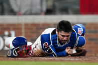 Atlanta Braves catcher Travis d'Arnaud (16) lies on the ground after Philadelphia Phillies' Alec Bohm scored the go-ahead run in the ninth inning of a baseball game Sunday, April 11, 2021, in Atlanta. (AP Photo/John Bazemore)