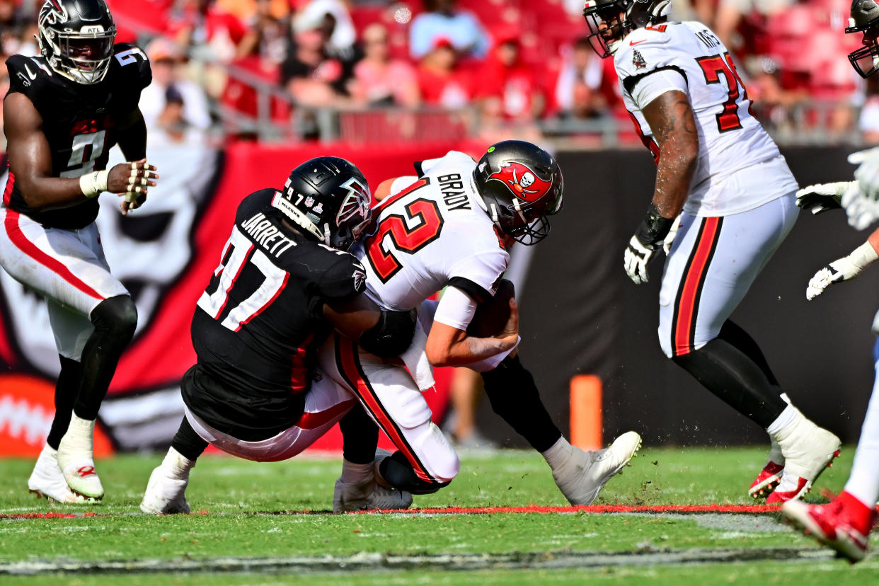 Grady Jarrett sacks Tom Brady during the fourth quarter of Sunday's Falcons-Bucs game. Jarrett was flagged for roughing the passer. (Julio Aguilar/Getty Images)