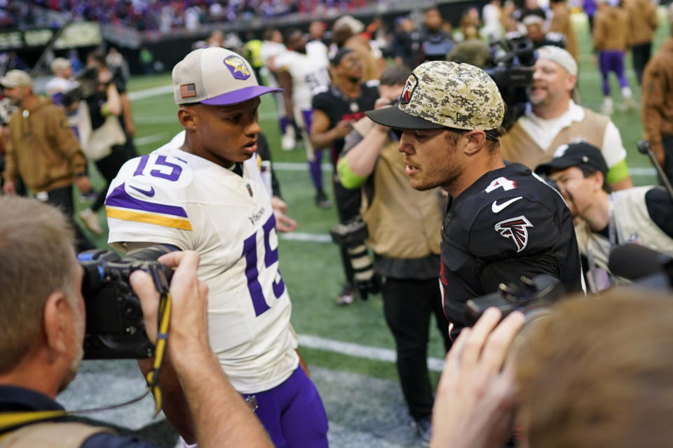 Minnesota Vikings quarterback Joshua Dobbs (15) and Atlanta Falcons quarterback Taylor Heinicke (4) meet on the field after an NFL football game, Sunday, Nov. 5, 2023, in Atlanta. (AP Photo/Mike Stewart)