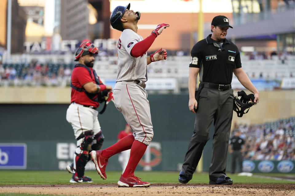 Boston Red Sox's Xander Bogaerts crosses home plate after hitting a grand slam against the Minnesota Twins during the third inning of a baseball game Wednesday, Aug. 31, 2022, in Minneapolis. (AP Photo/Abbie Parr)