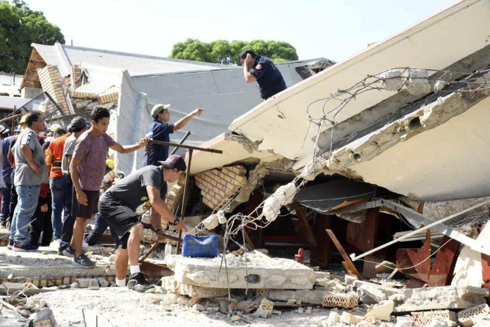 Rescue workers search for survivors amid debris after the roof of a church collapsed during a Sunday Mass in Ciudad Madero, Mexico, Sunday, Oct. 1, 2023. The Bishop of the Roman Catholic Diocese of Tampico said the roof caved in while parishioners were receiving communion. (Jose Luis Tapia/El Sol de Tampico via AP)