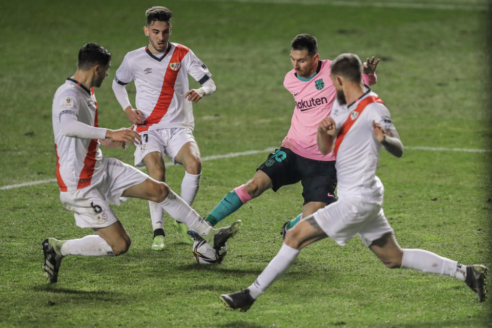 El delantero del Barcelona Lionel Messi controla el balón mientras lo rodean jugadores del Rayo Vallecano en el encuentro de los octavos de final de la Copa del Rey de España el miércoles 27 de enero del 2021. (AP Photo/Manu Fernandez)