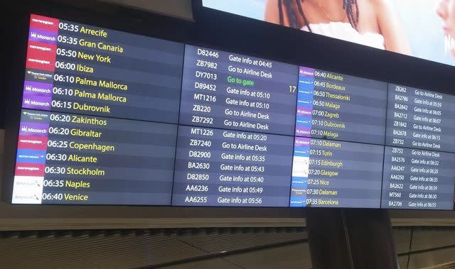 Information board directing Monarch passengers to the airline desk at Gatwick Airport