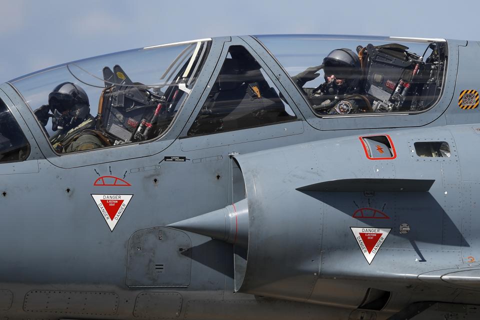 Greek crew of a Mirage 2000-5 salute as they taxi at Andravida air base, about 279 kilometres (174 miles) southwest of Athens, Tuesday, April 20, 2021. Greece vowed Tuesday to expand military cooperation with traditional NATO allies as well as Middle Eastern powers in a race to modernize its armed forces and face its militarily assertive neighbor Turkey. (AP Photo/Thanassis Stavrakis)