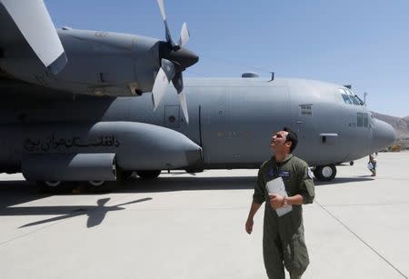 An Afghan Air Force pilot checks a C-130 military transport plane before a flight in Kabul, Afghanistan July 9, 2017. REUTERS/Omar Sobhani