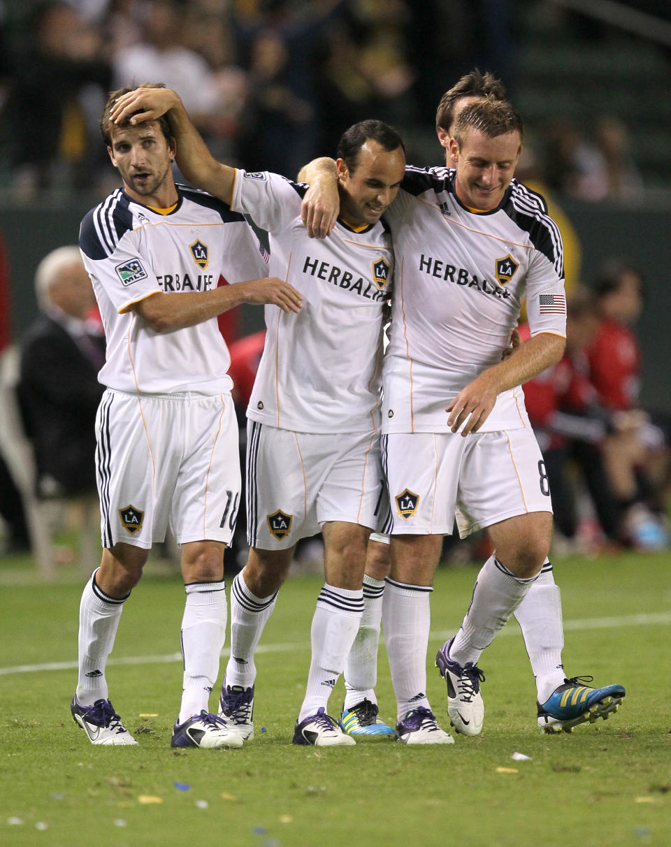 CARSON, CA - NOVEMBER 03: Landon Donovan #10 (C) of the Los Angeles Galaxy celebrates with Mike Magee #18 (L0 and Chris Birchall #8 after scoring on a penalty kick in the second half against the New York Red Bulls in their Western Conference Semifinal at The Home Depot Center on September 9, 2011 in Carson, California. The Galaxy won 2-1 to advance to the Conference Finals. (Photo by Stephen Dunn/Getty Images)