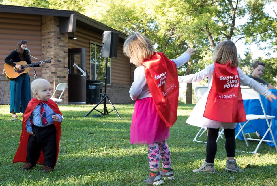 Children dance at Green Isle Park in Allouez while folk singer Kristen Graves, a 2000 Southwest High School graduate, performs at a picnic celebrating 50 years of the HSHS St. Vincent Children's Hospital NICU.