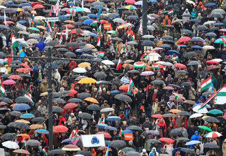 People attend Hungarian march at a pro-Orban rally during Hungary's National Day celebrations, which also commemorates the 1848 Hungarian Revolution against the Habsburg monarchy, in Budapest, Hungary March 15, 2018. Picture taken March 15, 2018. REUTERS/Bernadett Szabo