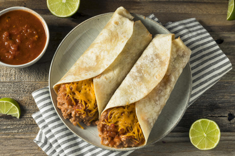 Bean and cheese burritos on a plate.