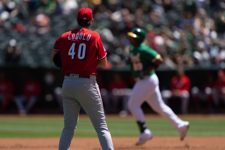 Apr 30, 2023;  Oakland, California, USA;  Cincinnati Reds starting pitcher Nick Lodolo (40) watches Oakland Athletics first baseman Jesus Aguilar (99) run the bases after hitting a two run home run at RingCentral Coliseum.  Mandatory Credit: Stan Szeto-USA TODAY Sports