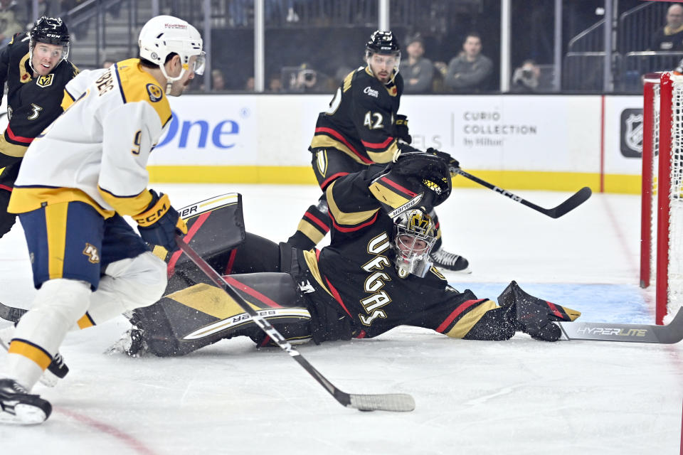 Vegas Golden Knights goaltender Logan Thompson (36) defends his goal against Nashville Predators left wing Filip Forsberg (9) during the first period of an NHL hockey game Saturday, Dec. 31, 2022, in Las Vegas. (AP Photo/David Becker)