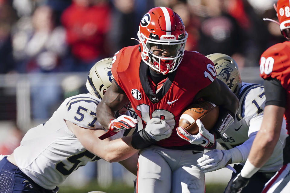 Georgia wide receiver Kearis Jackson (10) tries to go between Charleston Southern's Nick Bartalo (57) and Jackson Beerman (17) as he returns a punt in the first half of an NCAA college football game Saturday, Nov. 20, 2021, in Athens, Ga. (AP Photo/John Bazemore)