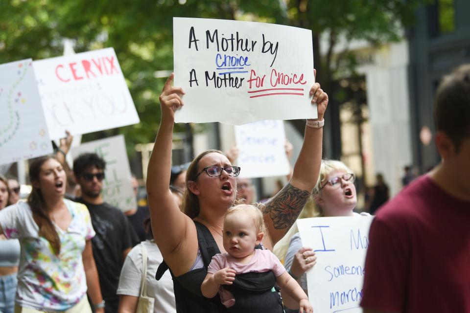 Kylie Hall and her daughter Amara, 14 months, attend a June 26 rally in downtown Knoxville in support of abortion rights and in response to the overturning of Roe v. Wade. The U.S. Supreme Court ruled 6-3 that Americans no longer have a constitutional right to abortion and erased a reproductive right the high court established nearly five decades ago.