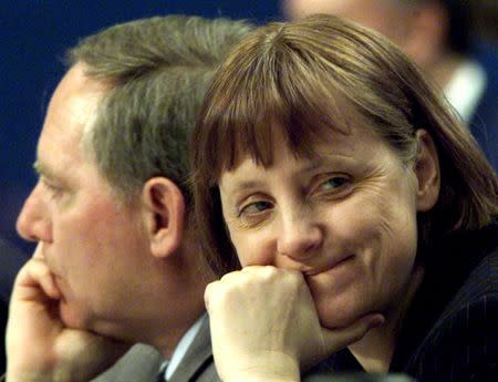 FILE PHOTO: Wolfgang Schaeuble (L), outgoing opposition Christian Democratic (CDU) party leader and designated party chairwoman Angela Merkel are seen during the CDU party convention in Essen April 10. REUTERS/Michael Urban/File Photo