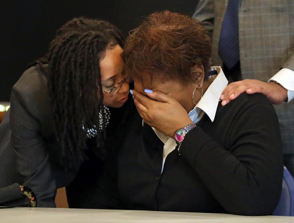 Pamela Walker is comforted by Paige White, one of the attorneys representing the Walker family, during a new conference Friday at the First Congregational Church of Akron.