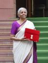 Indian Finance Minister Nirmala Sitharaman poses for photographs with a red pouch containing budget documents as she arrives to present the federal budget in the Parliament in New Delhi, India, Tuesday, July 23, 2024. (AP Photo)