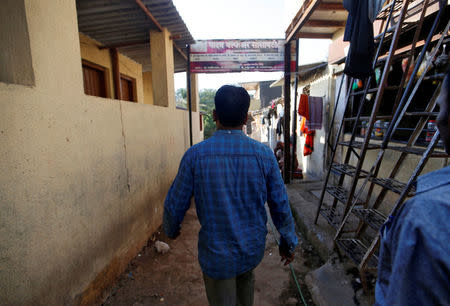 The father of a boy, who according to the father committed suicide after he was sexually assaulted last year, walks in an alley outside his house in Mumbai, India, April 26, 2018. Picture taken April 26, 2018. REUTERS/Francis Mascarenhas