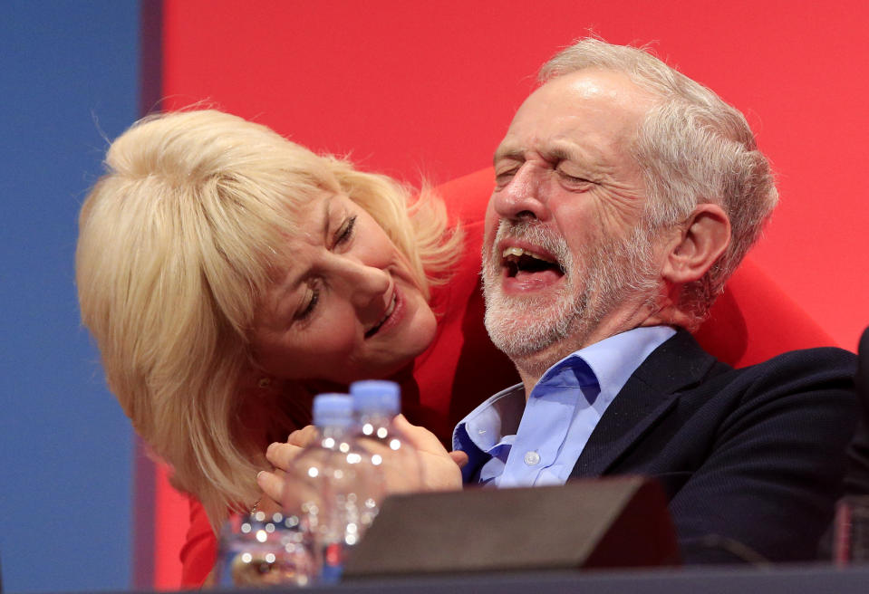 Labour leader Jeremy Corbyn laughs next to Jennie Formby during the second day of the Labour Party conference in Brighton, Sussex.