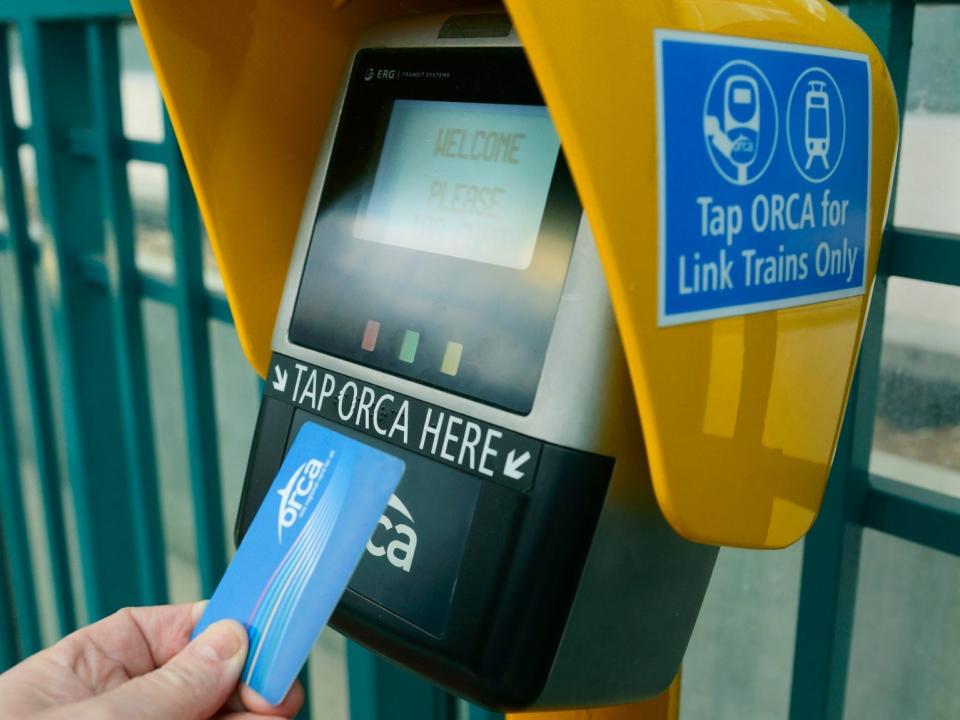 A person taps their ORCA card to pay for a ride on public transportation in Seattle, Washington.