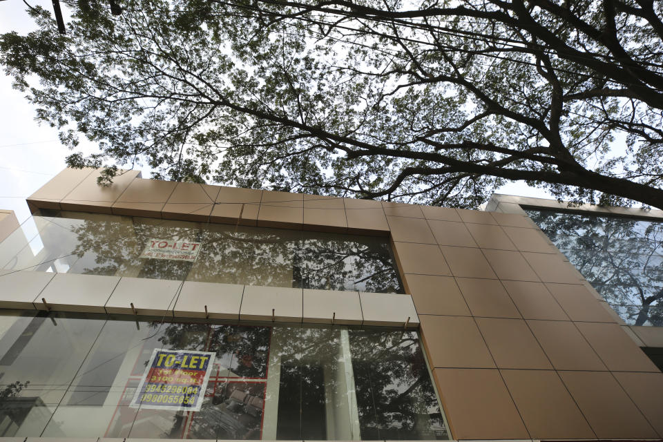 A to-let sign is displayed on the glass of a building which housed a designer Italian furniture store before it closed down due to pandemic in Bengaluru, India, Thursday, Oct. 8, 2020. Thousands of students and professionals who worked for IT companies and lived in the area have moved back to their native places to work remotely. Even as much of the Indian economy has reopened, Bengaluru’s professional workforce is returning to work at a much slower pace than those in most other major cities, raising the risk that the city faces a more protracted recovery. (AP Photo/Aijaz Rahi)