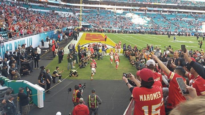 Players run on a field in the Super Bowl.