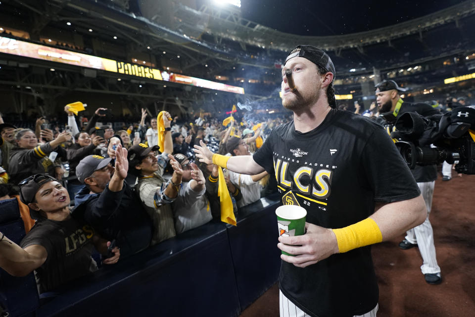 San Diego Padres second baseman Jake Cronenworth celebrates with fans after the Padres defeated the Los Angeles Dodgers 5-3 in Game 4 of a baseball NL Division Series, Saturday, Oct. 15, 2022, in San Diego. (AP Photo/Jae C. Hong)