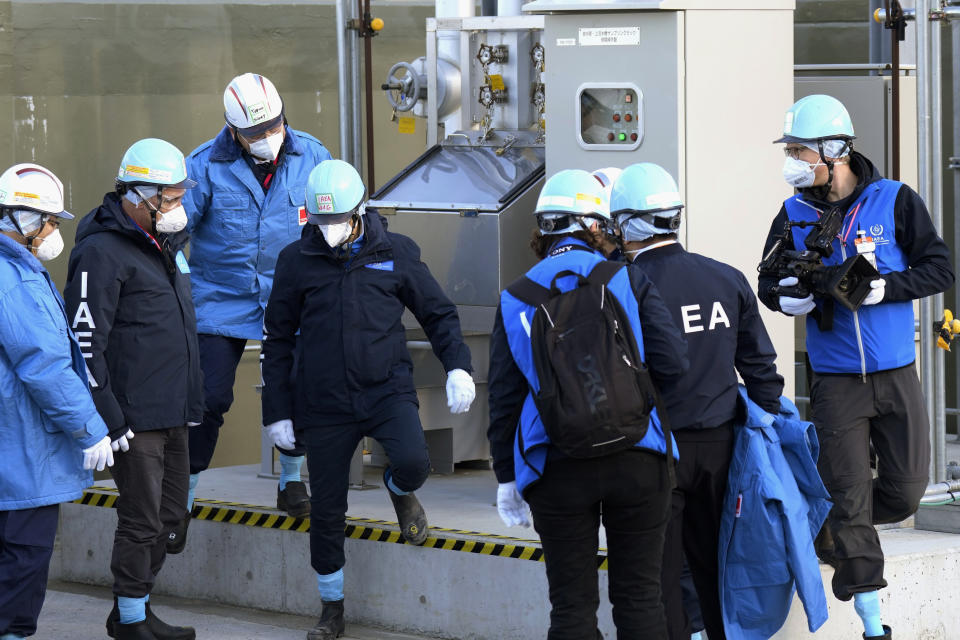 International Atomic Energy Agency Director General Rafael Mariano Grossi, center, visits a facility for sampling treated and diluted radioactive water at the Fukushima Daiichi nuclear power plant, operated by Tokyo Electric Power Company Holdings (TEPCO), in Futaba town, northeastern Japan, Wednesday, March 13, 2024. (AP Photo/Eugene Hoshiko, Pool)