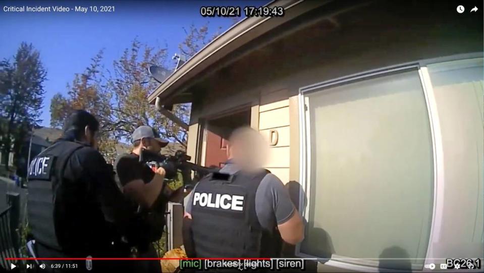 In a screenshot from body camera video, Det. Luca Benedetti, middle, calls out for Edward Giron after a fellow officer rammed open the door at Giron’s Camellia Court apartment in San Luis Obispo on May 10, 2021. Moments later, Giron shot and killed Benedetti.