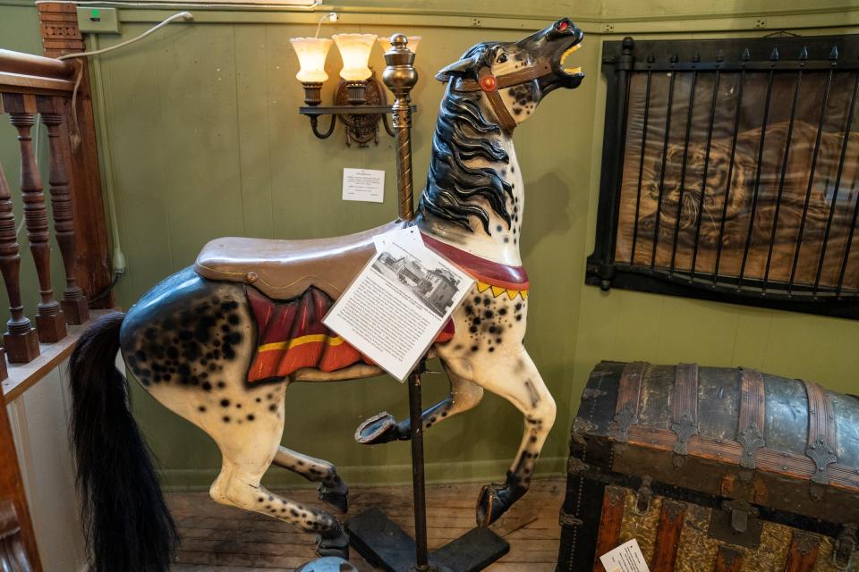 A 1920 antique wood-carved carousel horse made by the Herschell-Spillman Company for the carousel at the Former Electric Park in Detroit, on Sept. 28, 2022, is for sale inside Materials Unlimited antique store in Ypsilanti. After 50 years, the store will be closing this winter.