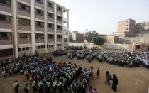 Students line up on the first day of their new school year at a government school in Giza, south of Cairo September 22, 2013. Students resumed their studies at the beginning of the new academic year this weekend amid parental concerns of a possible lack of security after the summer vacation ends. REUTERS/Mohamed Abd El Ghany (EGYPT - Tags: POLITICS EDUCATION)