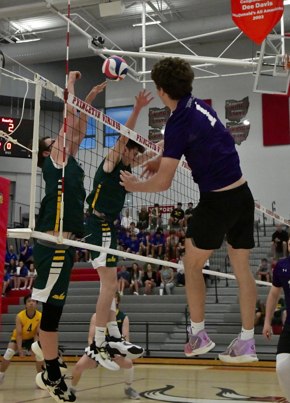 Drew Maune (1) of Elder powers the ball over the net past the Sycamore defense for a Panther score at the OHSBVA South Region championships, May 28, 2022.