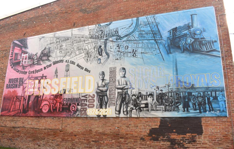 A mural that was created in 2023 and completed in early October by Blissfield artist and business owner Barrett Dvorsky honors the village's 200 years and its bicentennial in 2024. The mural includes images of Blissfield's reliance on the rail industry, pays homage to its nickname of "Sugar Boys" and features the famous triple bridges.