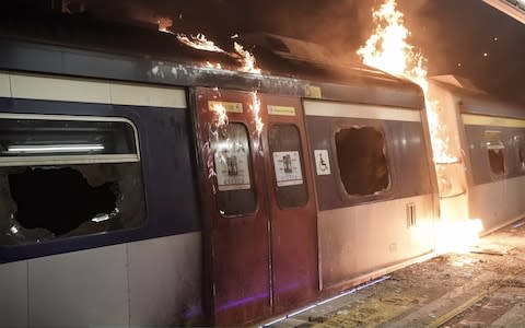 A train car burns at a MTR station during a demonstration at Chinese University of Hong Kong - Credit: Anthony Kwan/Getty