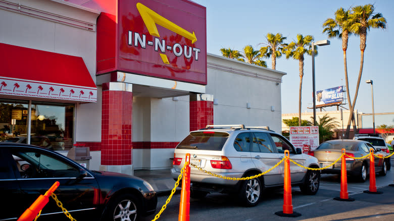 The exterior of an In-N-Out location with a busy drive-thru