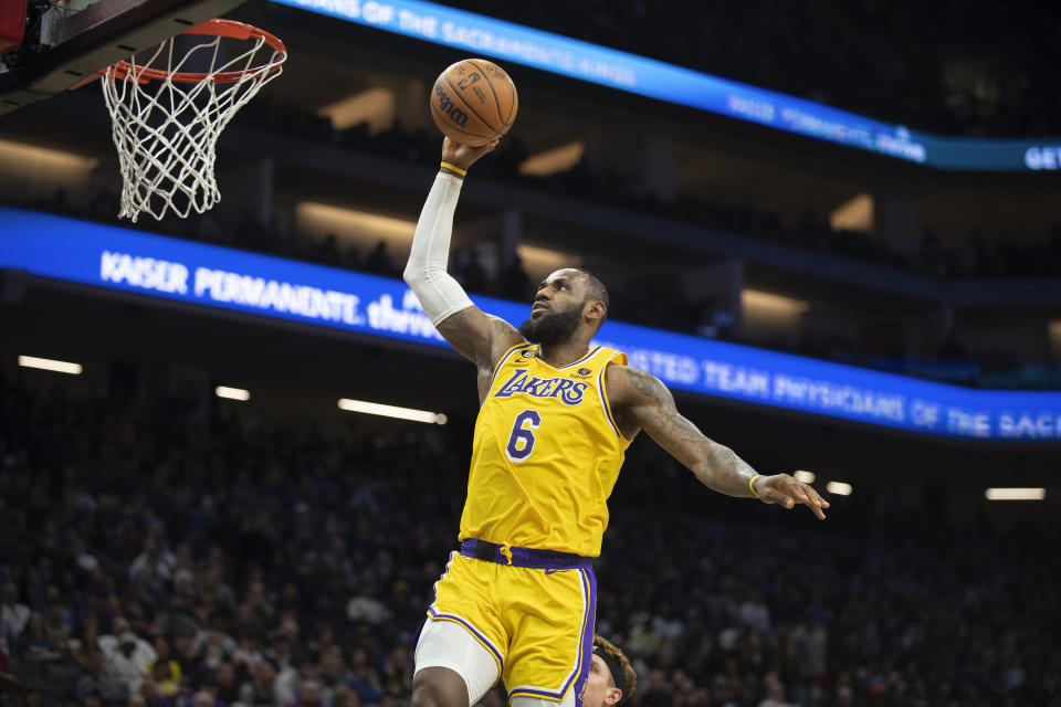 Los Angeles Lakers forward LeBron James scores a basket against the Sacramento Kings during the second half of an NBA basketball game in Sacramento, Calif., Wednesday, Dec. 21, 2022. The Kings won 134-120. (AP Photo/José Luis Villegas)