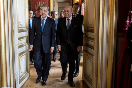 French Foreign Minister Jean-Yves Le Drian and Chinese Foreign Minister Wang Yi arrive for a Franco Chinese seminar of global governance in Quai d'Orsay in Paris, France, March 25, 2019. Julien de Rosa/Pool via REUTERS