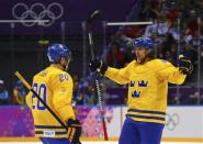 Sweden's Erik Karlsson (R) celebrates his goal against Finland with teammate Alexander Steen during the second period of the men's ice hockey semi-final game at the Sochi 2014 Winter Olympic Games, February 21, 2014. REUTERS/Mark Blinch