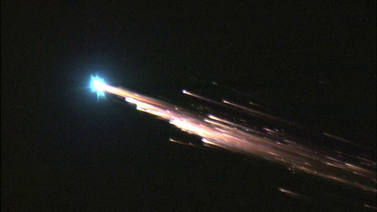  A bright fireball streaks across the sky. 