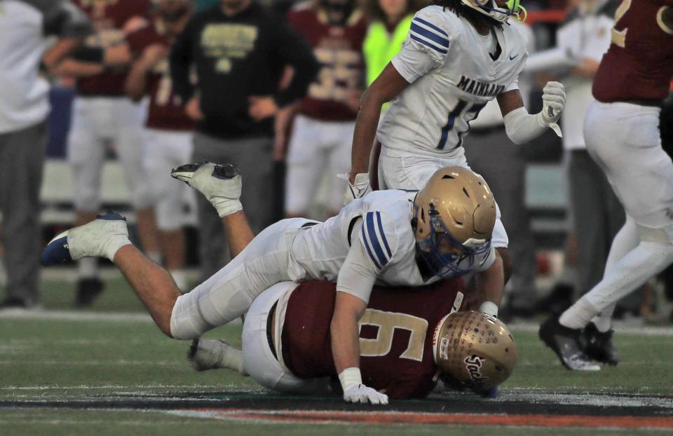 Mainland's Myron Shafer (7) tackles St. Augustine running back Devonte Lyons (6) during the Class 3S state championship game on Thursday in Tallahassee.