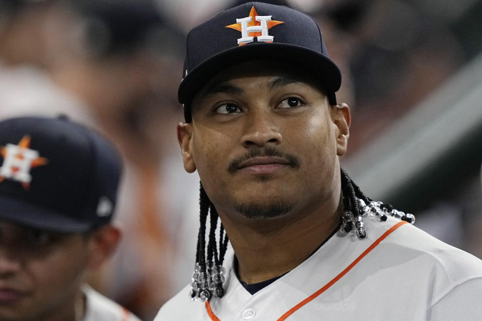 Houston Astros pitcher Luis Garcia looks at video presentation on the scoreboard before Game 1 of an American League Division Series baseball game against the Seattle Mariners in Houston, Tuesday, Oct. 11, 2022. Garcia and teammate Framber Valdez got hair extensions this season and will show off their unique locks this postseason as Houston tries to reach the World Series for the fourth time in six years. (AP Photo/David J. Phillip)