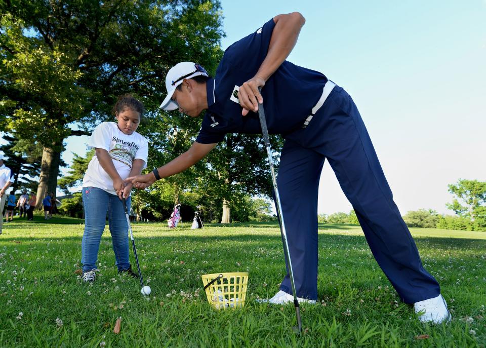 Golf pro Whee Kim, originally from South Korea, but now lives in Dallas, Texas, right, helps Paris Hare of Springfield, 9, of the Springfield Golf Club with her chipping technique at the Lincoln Greens Golf Course Tuesday July 12. 2022.