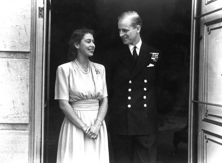 Princess Elizabeth and Lieut. Philip Mountbatten, whose engagement was announced, pose for their first engagement pictures at Buckingham Palace.