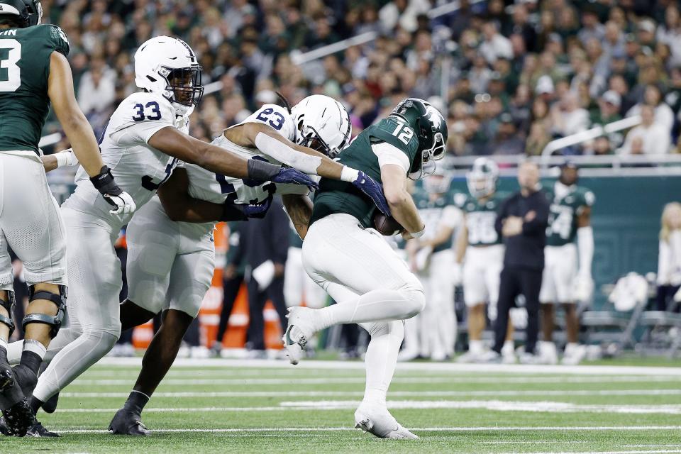 Michigan State quarterback Katin Houser is sacked by Penn State's Curtis Jacobs in the second quarter on Friday, Nov. 24, 2023, at Ford Field.