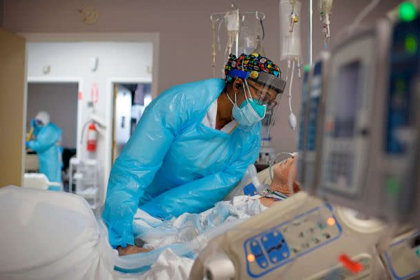 PHOTO: FILE - Healthcare worker Demetra Ransom comforts a patient in the Covid-19 ward at United Memorial Medical Center in Houston, Dec. 4, 2020. (Mark Felix/AFP /AFP via Getty Images, FILE)