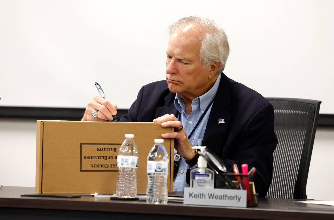 Wake County Board of Elections board member Keith Weatherly signs a box with ballots in it during a Wake County Board of Elections board meeting at the operations center in Raleigh, N.C., Tuesday, May 7, 2024. Ethan Hyman/ehyman@newsobserver.com