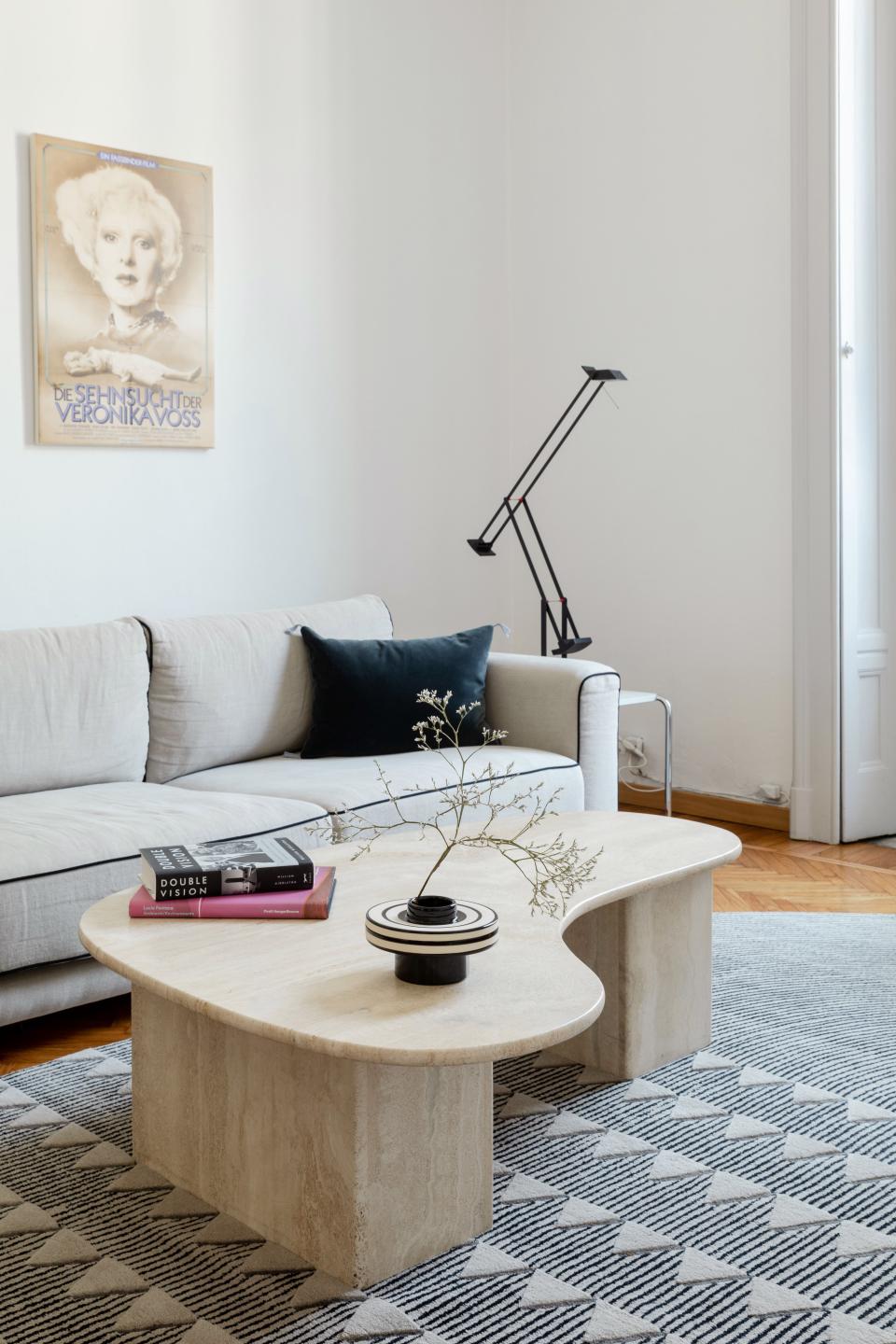 The living room is anchored by a David/Nicolas for CC-Tapis rug and a 1970s Italian travertine coffee table. Alex found his sofa at Caravane and a Tizio desk lamp by Richard Sapper sits atop Marcel Breuer’s Laccio side table for Knoll. On display above the sofa are posters of films by Rainer Werner Fassbinder from 1974 to 1982.